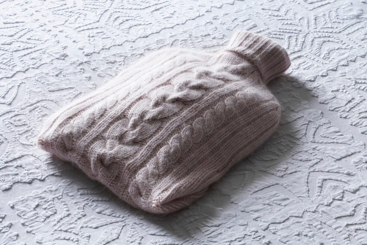 Hot water bottle on a bed