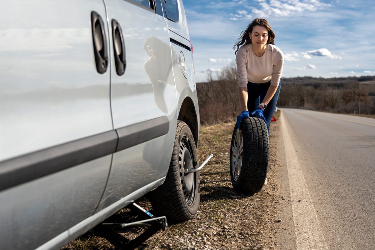 woman changing flat tire