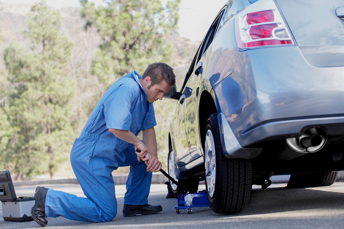 man using car jack