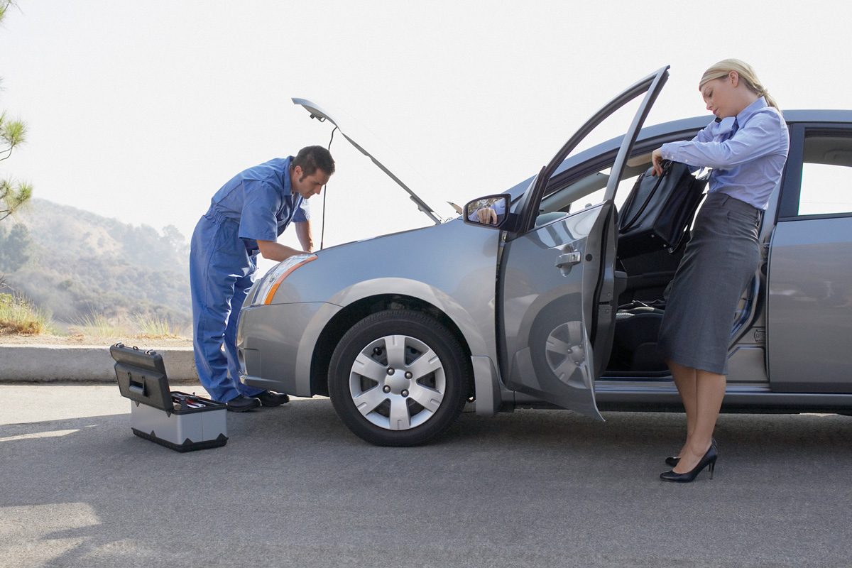 woman waiting for mechanic to fix car