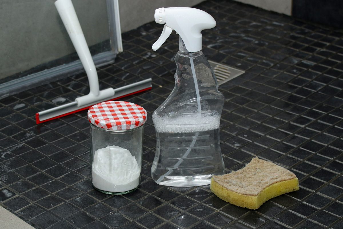 baking soda in ajar next to a spray bottle