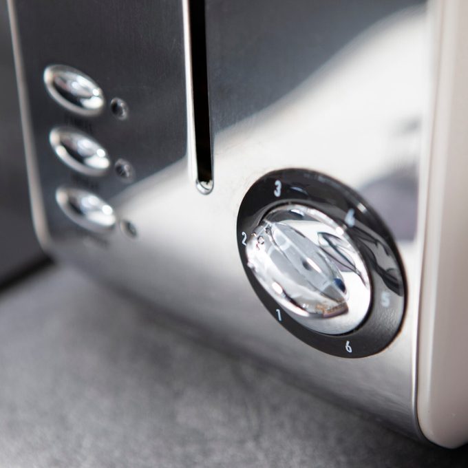 Close-up of the dial and buttons on a toaster