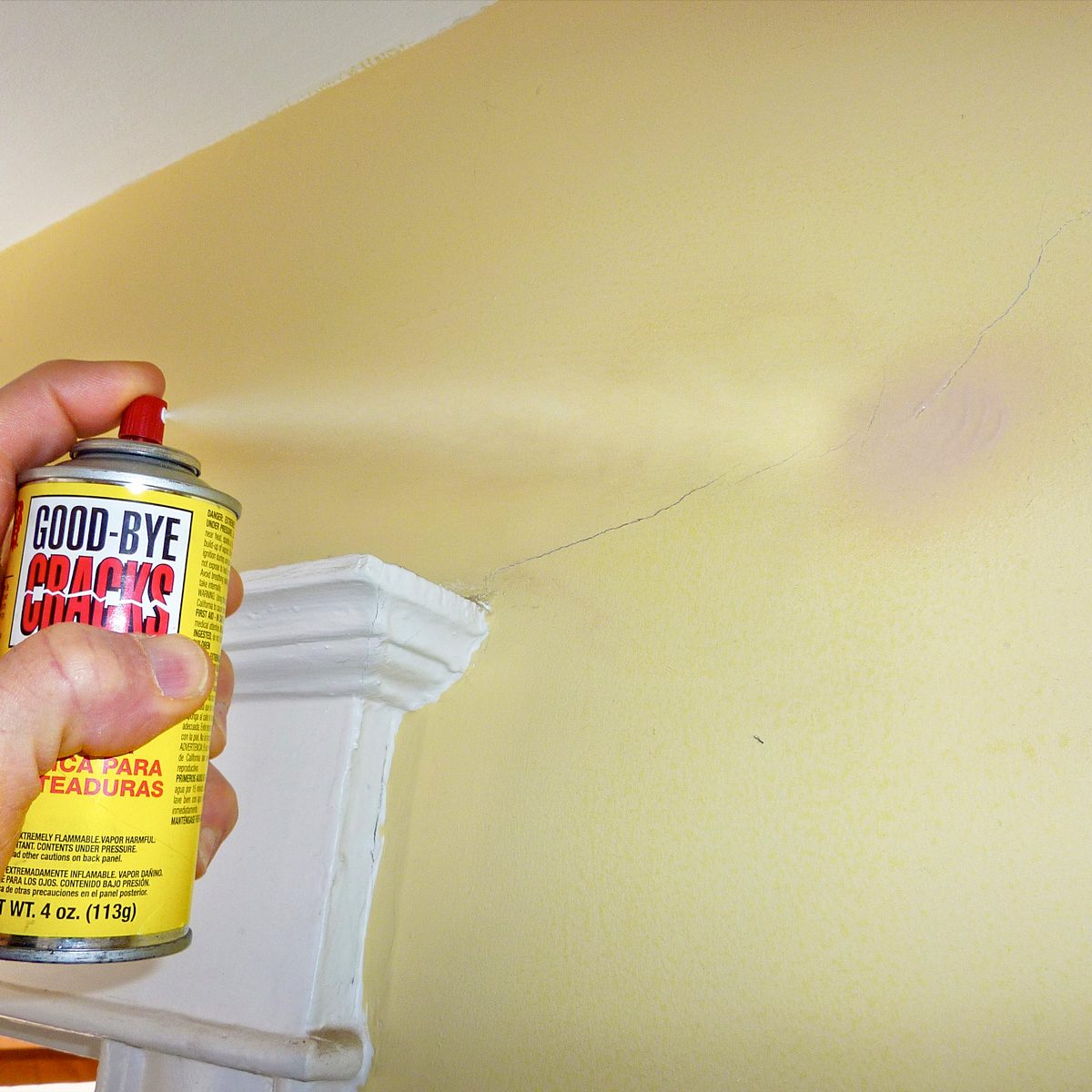 covering wall cracks with repair spray